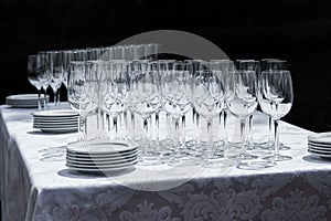 Wine glasses with plates on the table.