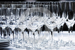 Wine glasses with plates on the table. Black background.