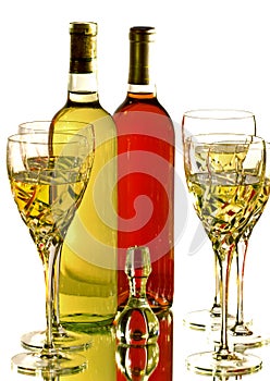 Wine glasses with red and white wine bottles