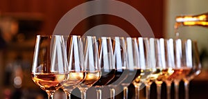 Wine glasses in a row. Pouring wine. Buffet table celebration of wine tasting. Nightlife, celebration and entertainment concept