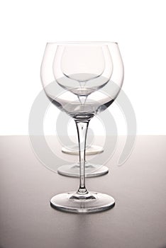 Wine glasses in a row on a white background