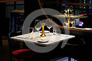 Wine glasses on a table in a restaurant awaiting guests