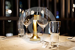 Wine glasses on a table in a restaurant awaiting guests