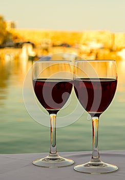 Wine glasses on the table with sea background