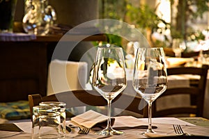 Wine glasses and table setting in restaurant photo