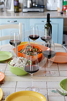 Wine glasses, wine bottle and empty plates on the table