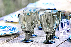 Wine glasses on a wooden table in countryside