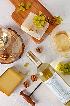 Wine, grapes, cheese and nuts. Top view