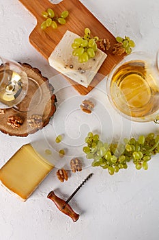 Wine, grapes, cheese and nuts. Top view