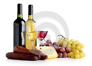 Wine, grapes, cheese an sausage isolated on white