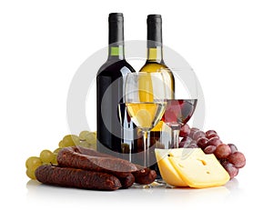 Wine, grapes, cheese an sausage isolated on white