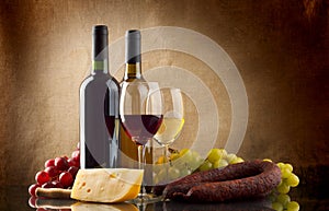 Wine, grapes, cheese an sausage on linen background