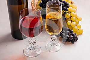 Wine and grapes. White and red wine in glasses and bottle of win