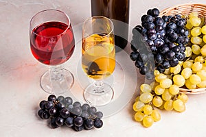Wine and grapes. White and red wine in glasses and bottle of win