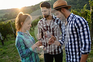 Wine grower and people in vineyard