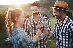 Wine grower and people in vineyard