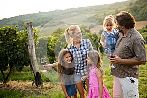 Wine growers tasting nice wine in vineyard