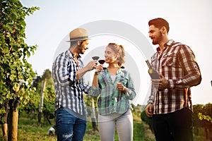 Wine growers tasting wine in vineyard