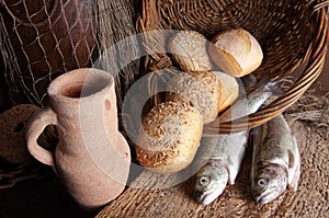 Wine jug with bread and fish