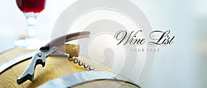 Wine list background with Copy space; a glass of red wine, a wine barrel and a corkscrew with a wine cork. Wine tasting at the