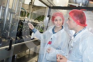 Wine makers using machinery at laboratory