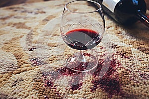 Wine mishap Red wine spills on carpet, creating a stain