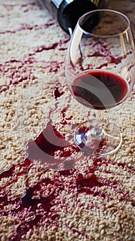 Wine mishap Red wine spills on carpet, creating a stain