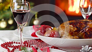 Wine pouring to glass on christmas table in front of fireplace