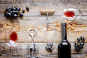 Wine set with bottle and grape on desk top view