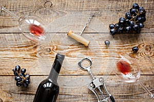 Wine set with bottle and grape on desk top view