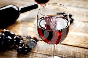 Wine set with bottle and grape on wooden desk