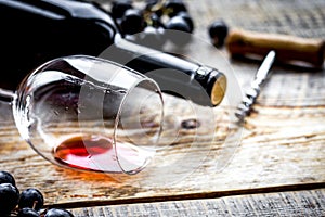 Wine set with bottle and grape on wooden desk