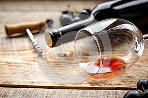 Wine set with bottle and grape on wooden desk