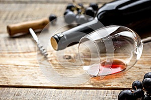 Wine set with bottle and grape on wooden desk