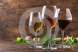 Wine set. Red, white and rose wine in assortment in wineglasses. Wine tasting, vintage wooden background, selective focus, copy