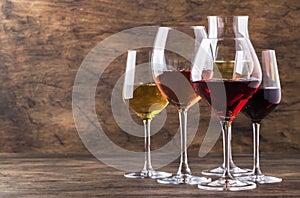 Wine set. Red, white and rose wine in assortment in wineglasses. Wine tasting, vintage wooden background, selective focus, copy