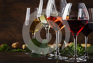 Wine set. Red, white and rose wine in assortment in wineglasses. Wine tasting, vintage wooden background, selective focus, copy