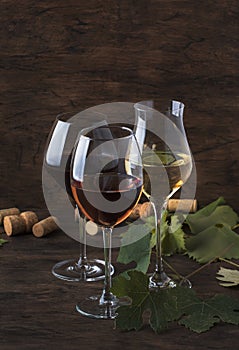 Wine set. Red, white and rose wine in assortment in wineglasses. Wine tasting, vintage wooden background, selective focus, copy