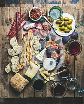 Wine and snack set with wines, meat, bread, olives, berries