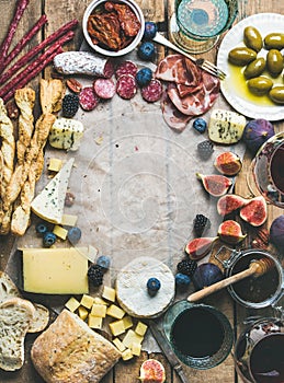 Wine and snack set with wines, meat, bread, olives, fruits