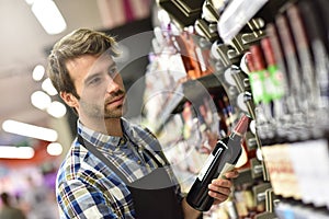 Wine specialist working at supermarket