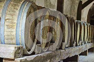 Wine storage in old wood barrels in cellar