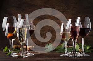 Wine tasting concept, still and sparkling wines. Red, white wine, rose and champagne in wine glasses on vintage wooden table