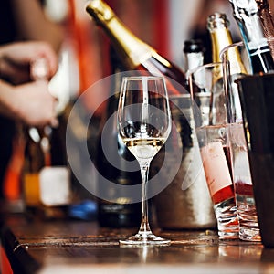 Wine tasting: a glass with the remains of wine is on the table next to the silver buckets.