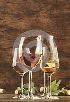 Wine tasting. Red, white, rose and champagne - still and sparkling wines sin glasses on vintage wooden table background photo