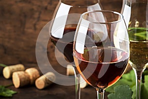 Wine tasting. Red, white, rose - still wines sin glasses on vintage wooden table background photo