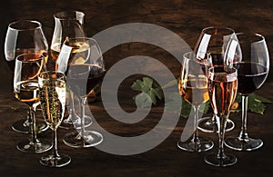 Wine tasting, still and sparkling wines. Red, white wine, rose and champagne ÑˆÑ‚ assortment in wine glasses on vintage wooden