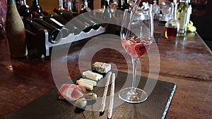 Wine test, crystal glass, red wine, cheese, bar counter background. Glasses of wine and cheese plate.