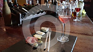 Wine test, crystal glass, red wine, cheese, bar counter background. Glasses of wine and cheese plate. Wine testing.