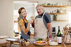 Wine, toast and senior couple in a kitchen for cooking, bonding and celebrating their relationship in their home. Happy